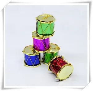 Close-up of colorful miniature Christmas drum ornaments with gold glitter wire accents