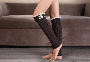 Detailed knit leg warmer with decorative white lace edging and classic white buttons