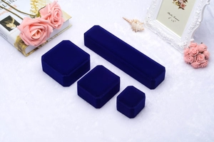 Detail of four royal blue velvet jewelry boxes for necklaces, rings and earrings