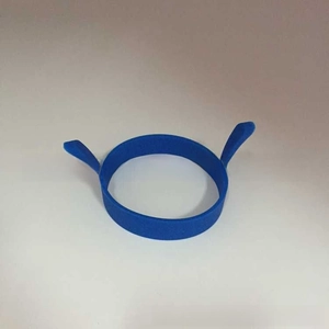 Close-up of blue silicone egg ring with dual handles for easy lifting and frying
