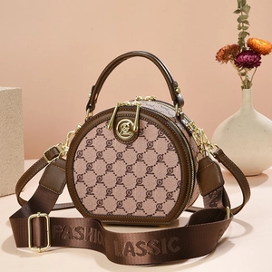 Classic round crossbody bag in brown jacquard leather with adjustable wide strap