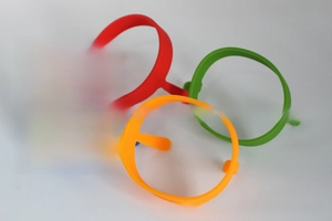 Set of four colorful silicone egg rings with heat-resistant handles for cooking pancakes