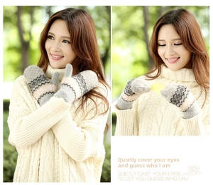 Detail of thick knitted mittens with Nordic geometric pattern and soft thermal texture
