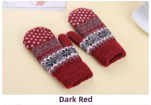 Detail of burgundy thick knit mittens with winter snowflake pattern for outdoor warmth