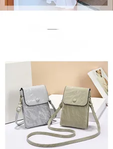 Close-up of small crossbody bags showing marble texture and round buckle details