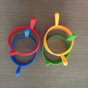 Detailed top view of red, blue, orange, and green silicone egg rings with side handles