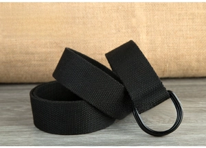 Detail of black canvas belt fabric texture and matte black metal double D-ring buckle