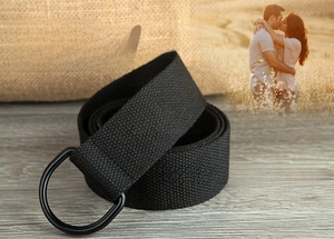 Detail of black woven canvas belt featuring matte double D-ring metal buckles and texture
