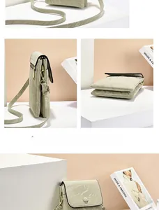 Detail view of small marble pattern crossbody bag with gold hardware and adjustable strap
