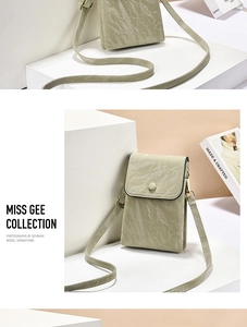 Macro shot of mint green crossbody bag with textured marble fold pattern and fine strap