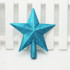 Close-up of a blue glittery five-pointed star topper for Christmas tree decoration