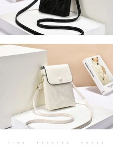 Detail view of mini marble pattern crossbody bag with gold hardware and flap closure