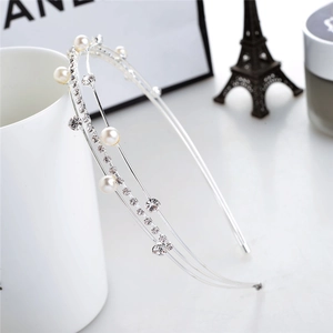 Detail of silver double-layered headband with elegant pearls and sparkling rhinestones