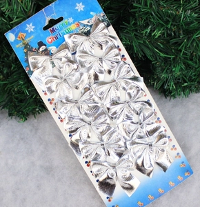 Lot de 12 nœuds de Noël argentés avec motif flocon sur carte de présentation festive