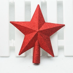 Close-up of a festive red glitter star tree topper with a conical base on white background