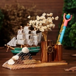 Detailed Mediterranean wooden sailboat pen holder with creative nautical shell decorations