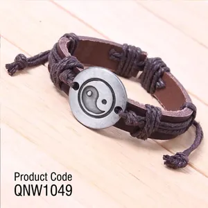 Retro Tai Chi leather bracelet with woven rope on a minimalist wooden background