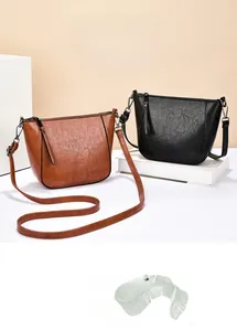Detail view of large capacity vintage crossbody bags in brown and black leather