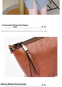 Detail of durable PU leather zipper pull with precise stitching on a brown tote bag