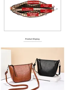 Detail view of the multi-compartment interior and matte leather finish of this shoulder bag