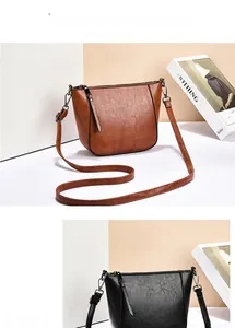 Detailed macro view of the vintage lychee pattern PU leather and gunmetal hardware on the bag
