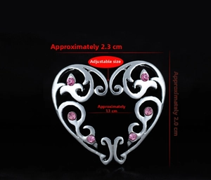Macro detail of adjustable heart-shaped nipple clip with pink rhinestones and size guide