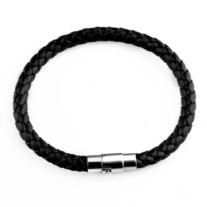 Detail of black braided leather bracelet with silver magnetic clasp on white background