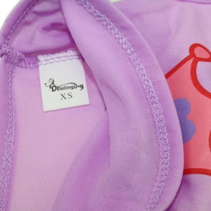 Detailed close-up of purple knit fabric with DroolingDog brand label and crown print