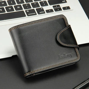 Classic black leather short wallet for men with secure snap closure on a laptop
