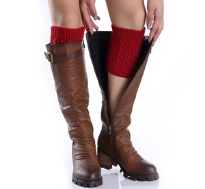 Detail of red cable knit leg warmers paired with brown leather boots for autumn