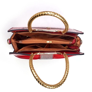 Top view of red faux crocodile leather handbag with three large inner compartments