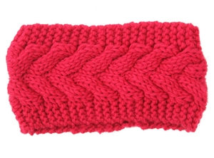 Detailed cable knit texture of a warm magenta winter headband in thick wool material