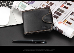 Detail of black bifold leather wallet featuring orange contrast stitching and embossed logo