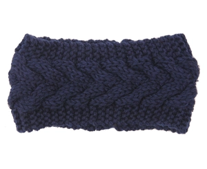 Close-up of navy blue knitted headband showing thick cable knit texture and warm wool fabric