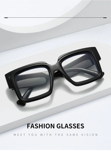 Detail of trendy thick black square frame glasses on a white geometric display stand