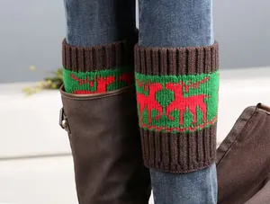 Close-up of knitted Christmas boot cuffs with red elk pattern and ribbed cuffs for winter