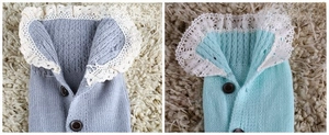 Detail of knitted leg warmers with delicate white lace trim and brown button accents
