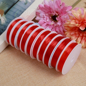 Macro detail of red elastic beading cord on spools for DIY jewelry making and crafts