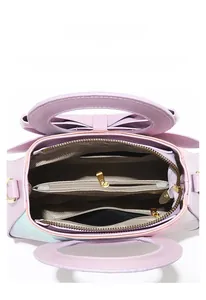 Internal view of lilac faux leather handbag showing multi-layer compartments and bow detail