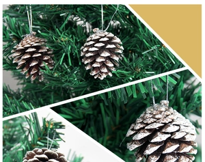 Close-up of natural pine cones with white snow tips hanging on a green Christmas tree