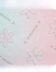 Macro detail of embossed floral pattern on gradient pink and green leather texture