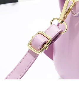 Detail of light purple leather shoulder strap with gold metal buckle and lobster clasp