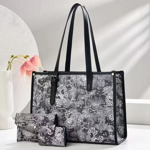 Close-up of elegant floral print bag set with tote, flap wallet and compact card holder