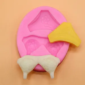 Detailed pink silicone mold for DIY baking showing bra and panty shapes with floral patterns