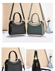 Detail view of contrast color handbag showing leather texture and metallic gold handle