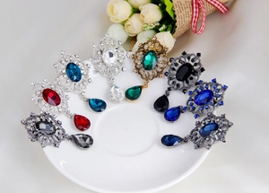 Detail of assorted vintage leaf brooches with sparkling crystals and drop pendants