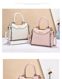 Detail view of the elegant textured panels and gold metal handle of the shoulder bag