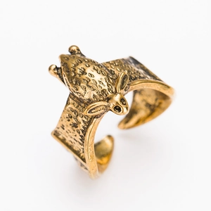 Detailed macro view of bronze bat wing ring with vintage oxidized metal texture