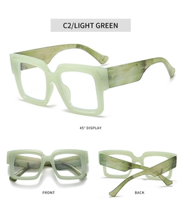 Detail view of light green oversized square glasses featuring unique marble pattern temples