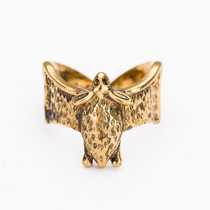 Detailed macro view of the antique gold bat-shaped alloy ring with vintage texture